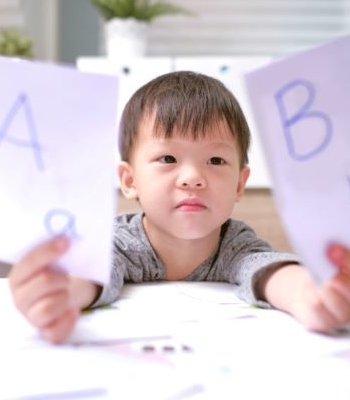 child holding letters